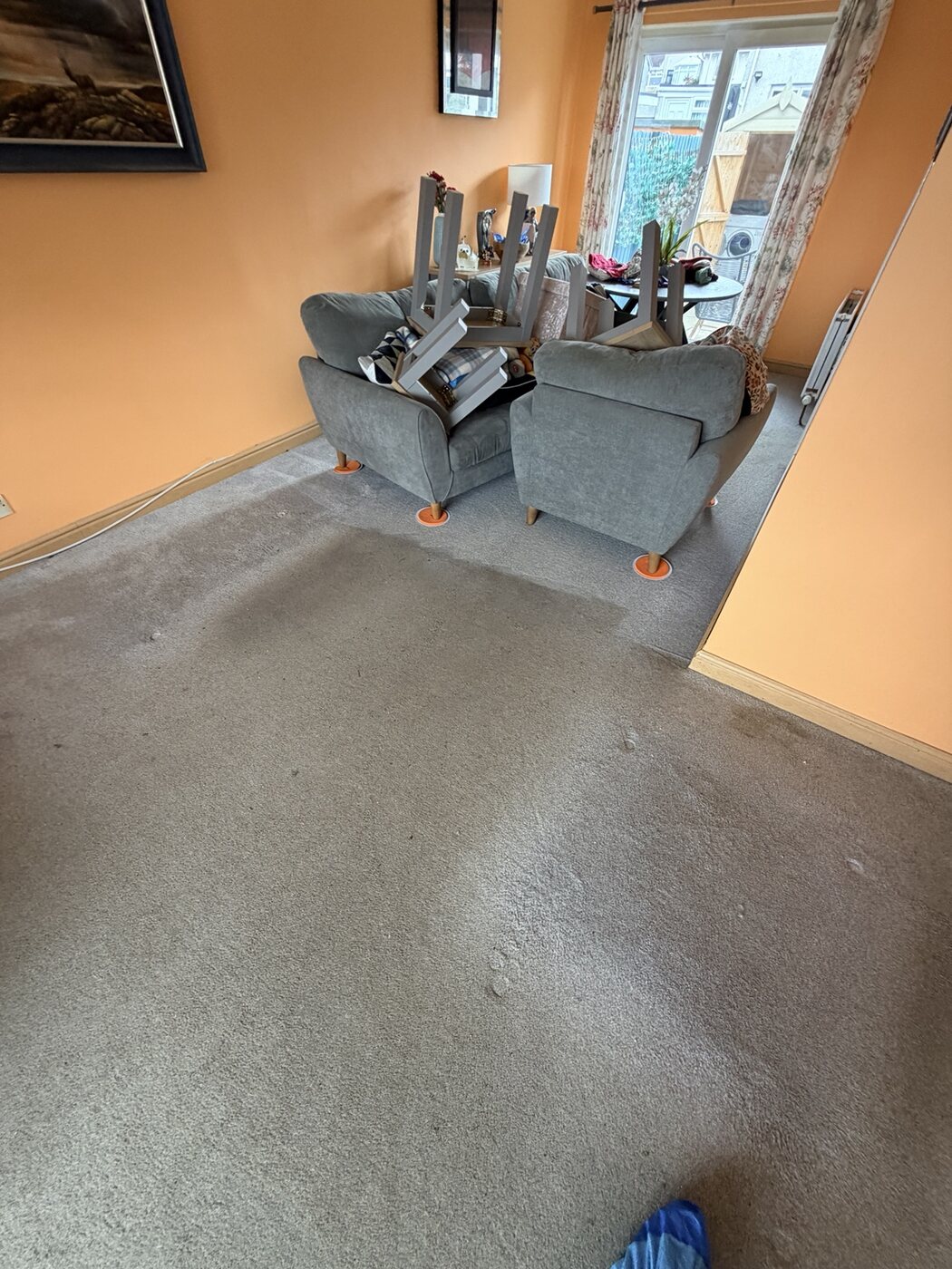 Furniture raised on orange glides during professional carpet cleaning in an Armadale family home
