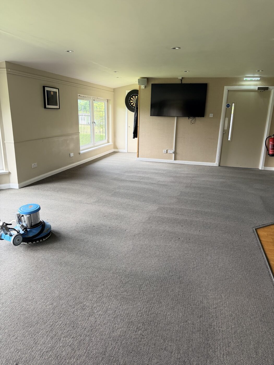 Low-moisture rotary carpet cleaning in progress